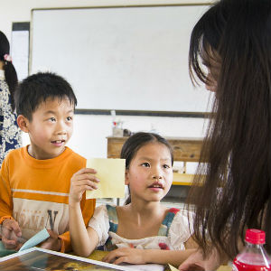 Kids inside a classroom with a teacher