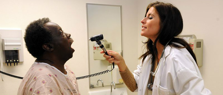 Nurse Examines Patient's Throat